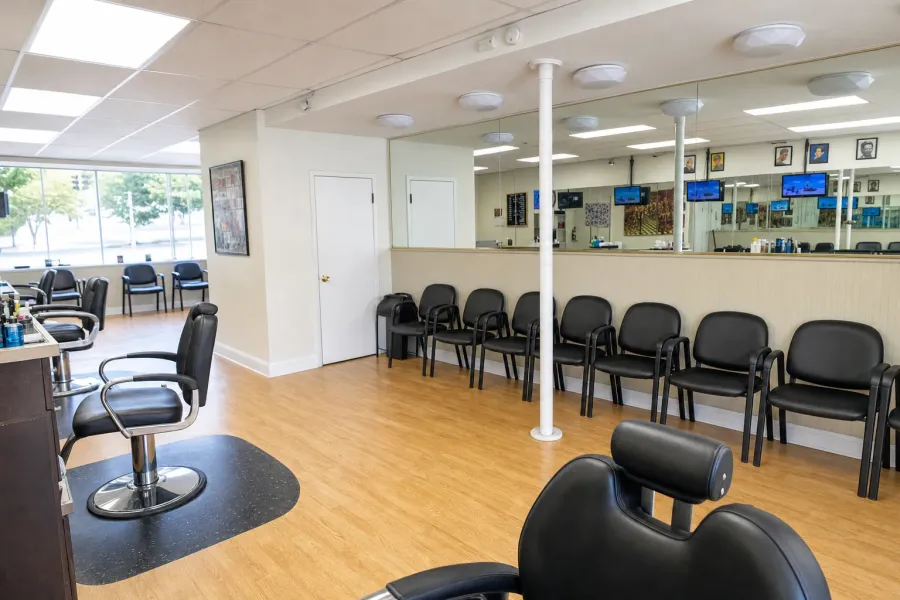 Inside Urban Fellow Barbershop & Shave Parlor — mirrors, black chairs, light wood floor