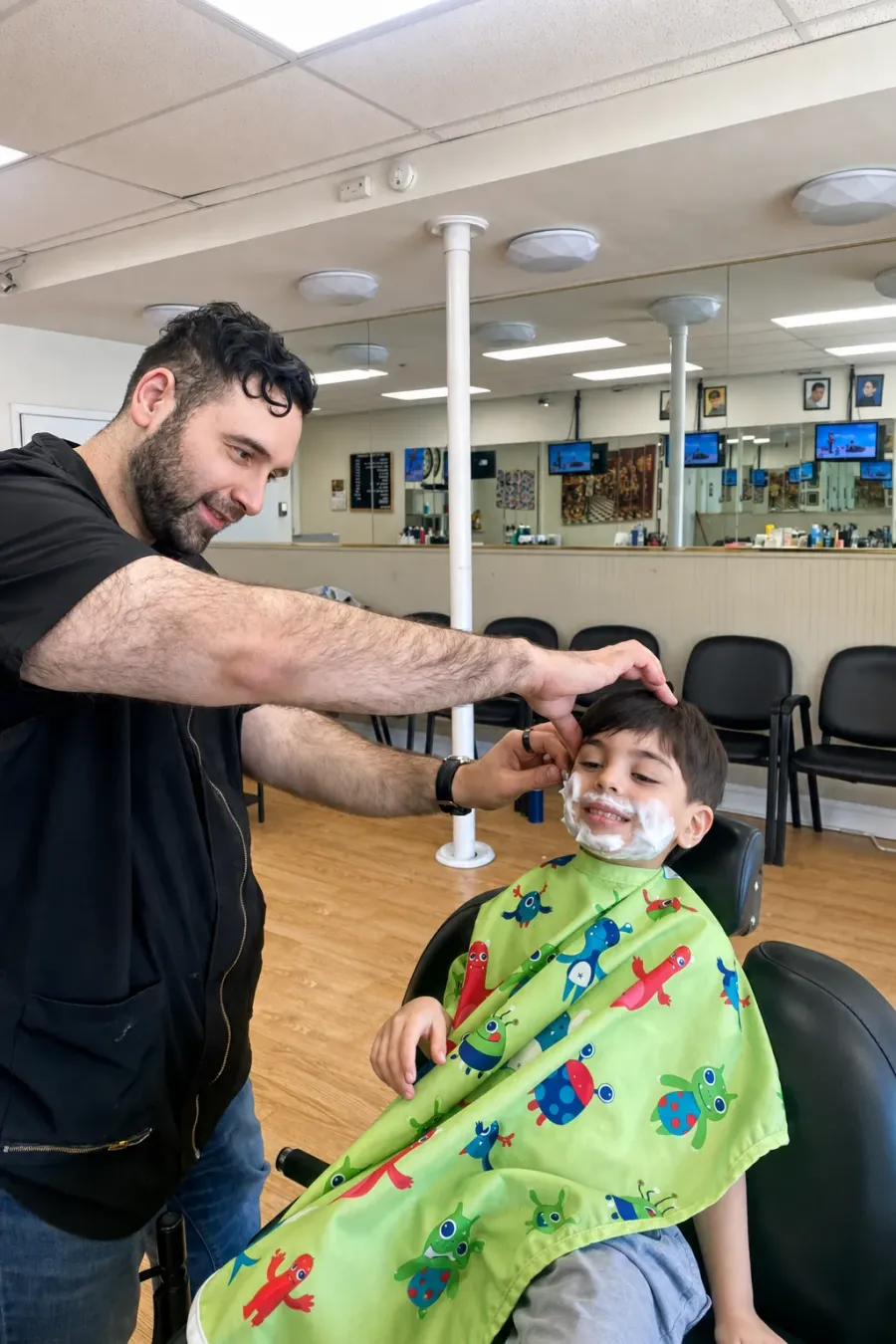 A young customer getting a kids’ haircut at Urban Fellow Barbershop & Shave Parlor