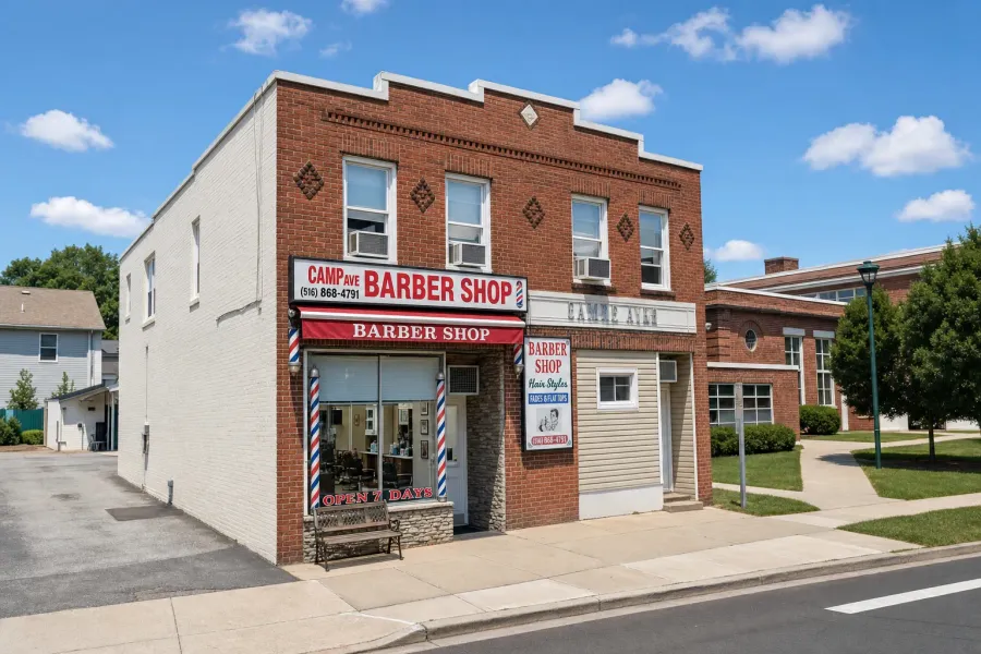 Urban Fellow Barbershop & Shave Parlor storefront in Providence, NY — red awning, two barber poles, brick corner building
